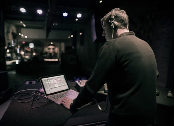 rear-view-man-using-laptop-while-standing-nightclub-min-1024x681